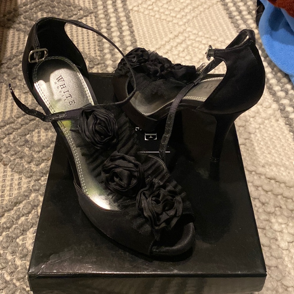 Worn once.  Black heels with flowers up the center.